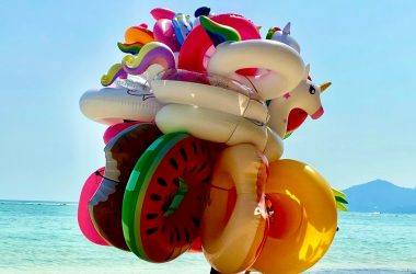 white blue and red inflatable inflatable balloon on beach shore during daytime